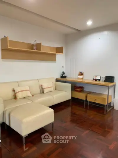 Modern living room with sleek furniture and wooden flooring, perfect for stylish urban living.