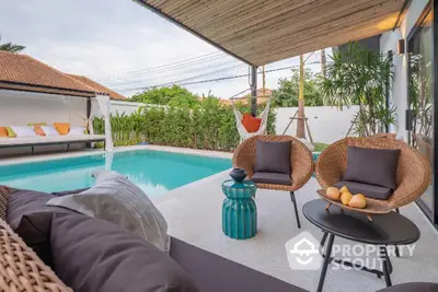 Luxurious outdoor pool area with stylish seating and lush greenery