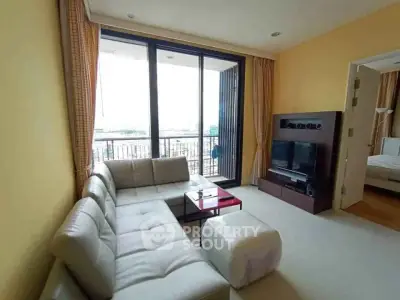 Spacious living room with modern decor and balcony view in a luxurious apartment.
