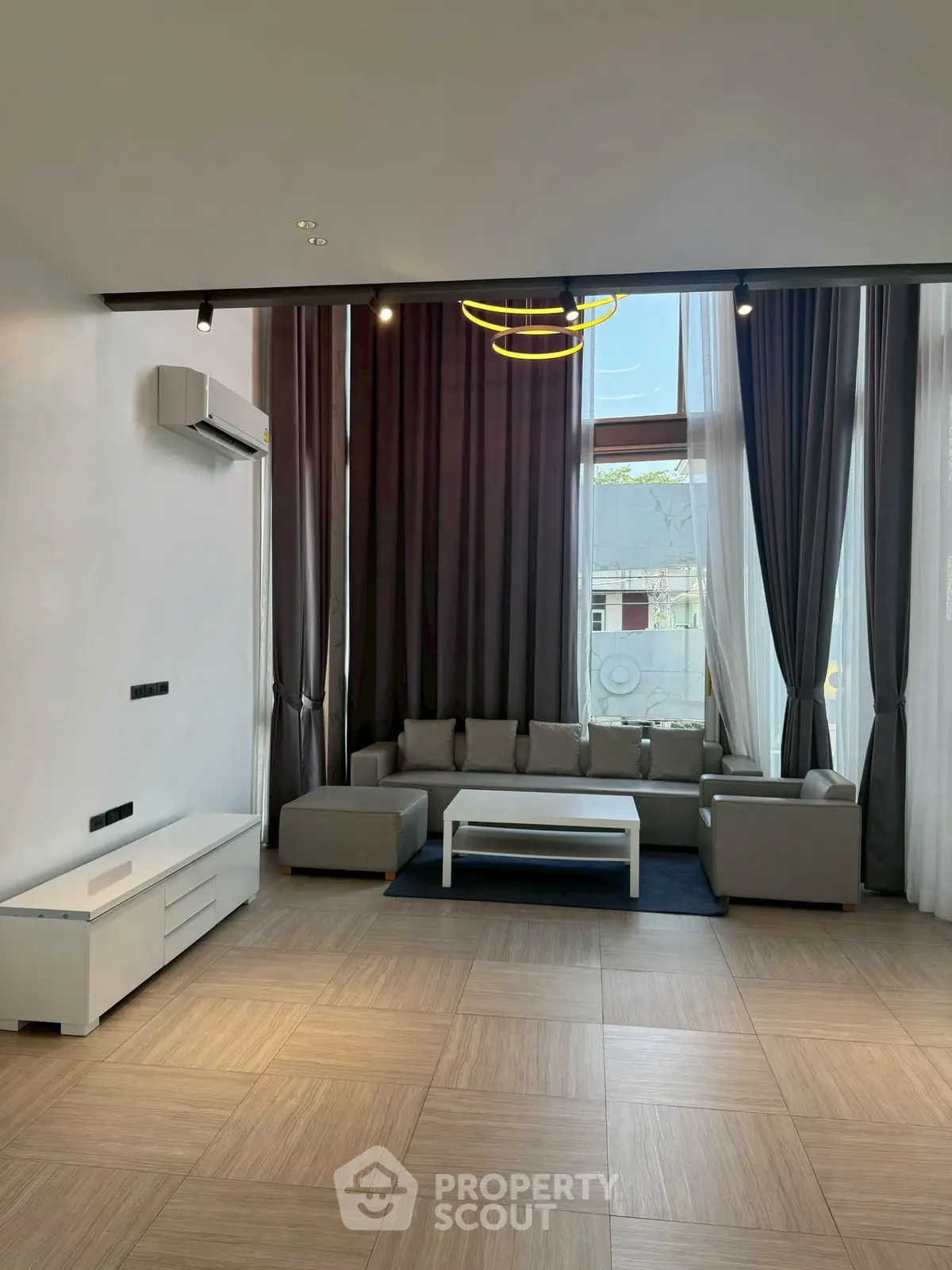 Spacious modern living room with high ceilings and elegant decor