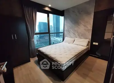 Modern bedroom with city view and stylish decor in high-rise apartment