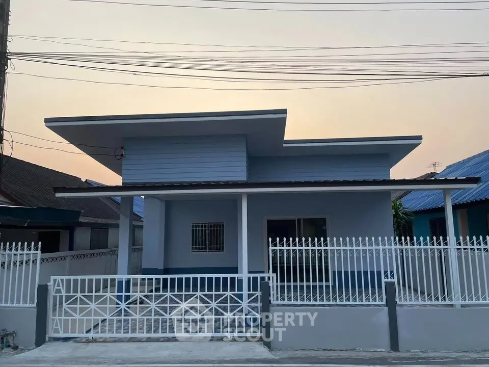 Charming single-story home with modern facade and gated entrance, perfect for family living.