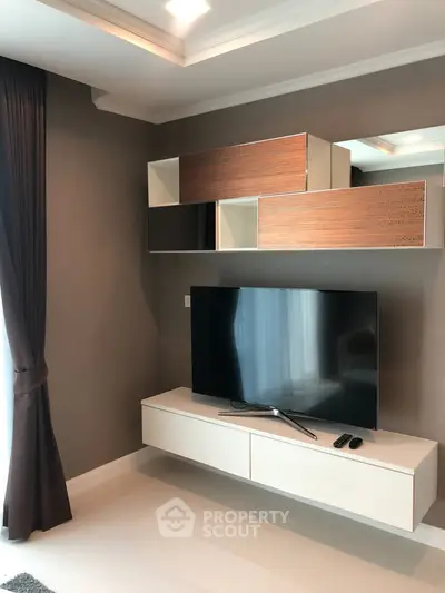 Modern living room with sleek TV unit and stylish wall cabinets