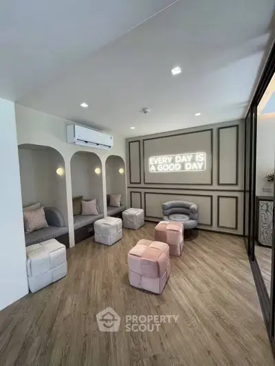 Stylish modern living room with cozy seating and inspirational wall art, perfect for relaxation.