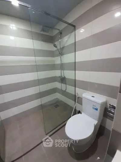 Modern bathroom with glass shower enclosure and sleek tile design