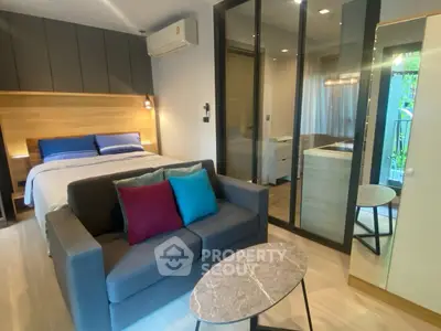 Modern studio apartment with stylish decor and cozy living area.