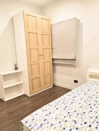 Cozy bedroom with wooden wardrobe and modern decor