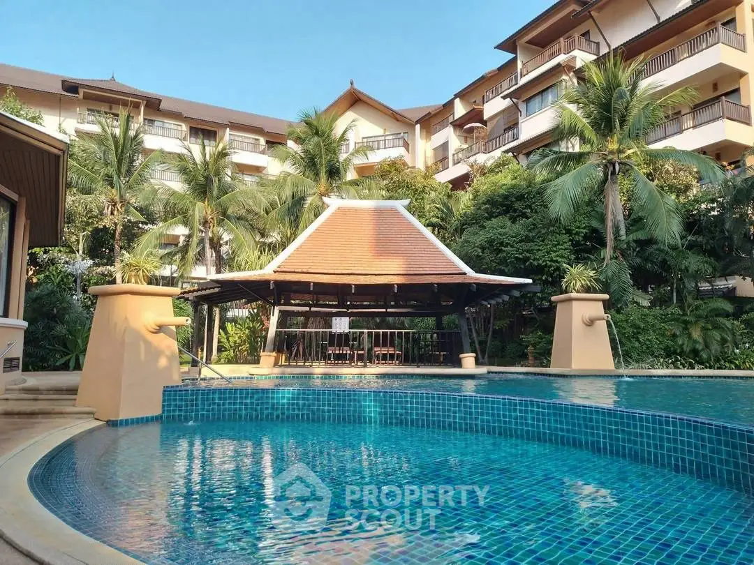 Luxurious resort-style pool area with tropical landscaping and elegant architecture.