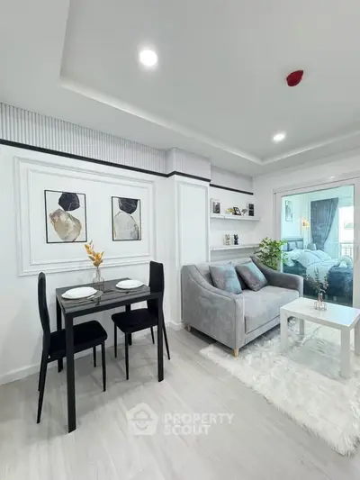 Modern living room with elegant decor and cozy dining area in a stylish apartment.