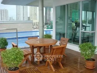 Luxurious balcony with wooden furniture and city view, perfect for relaxation and entertainment.
