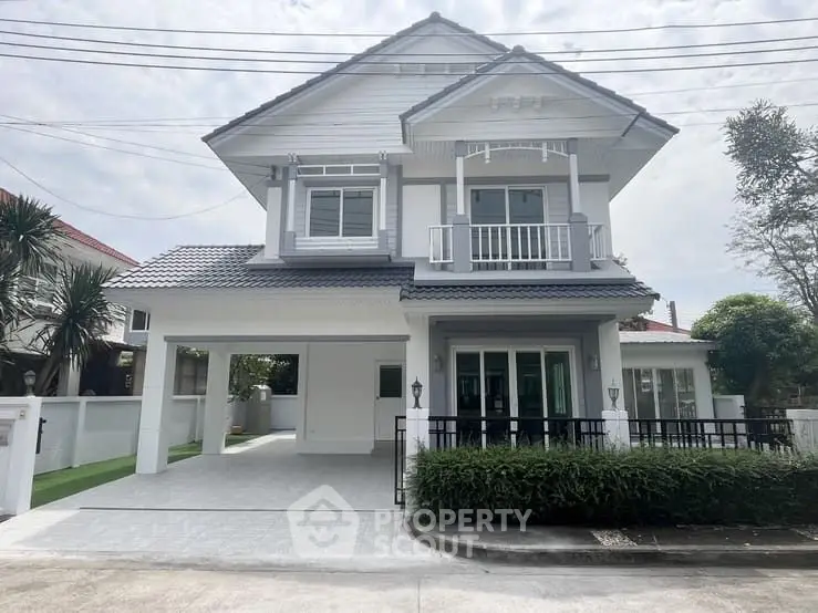 Charming two-story house with modern design and spacious driveway in a serene neighborhood.