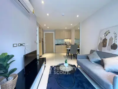 Modern living room with stylish decor and open kitchen layout in a cozy apartment.