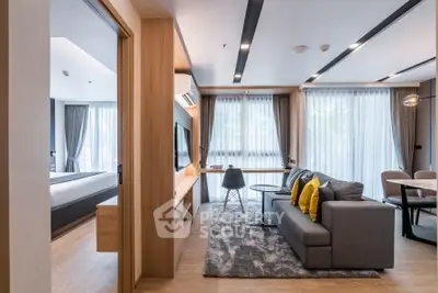 Modern living room with stylish decor and large windows in a contemporary apartment.