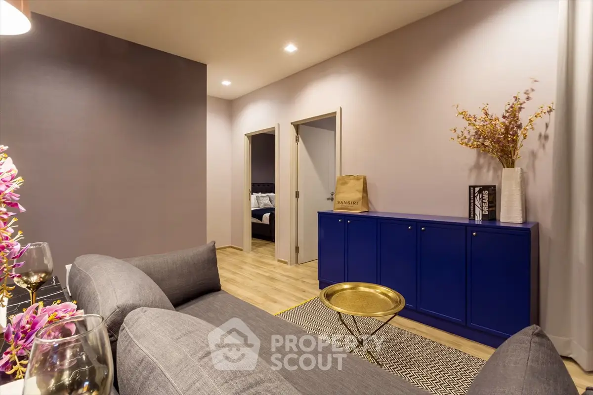 Stylish living room with modern decor and vibrant blue cabinet