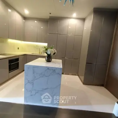 Luxurious modern kitchen with sleek cabinetry and marble island