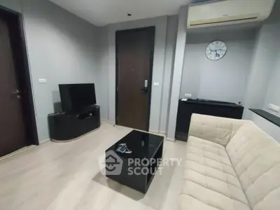 Modern living room with sleek furniture and air conditioning, perfect for comfortable urban living.