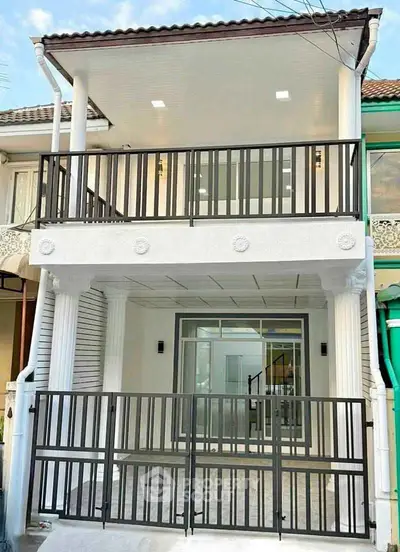 Modern two-story house with balcony and stylish railing