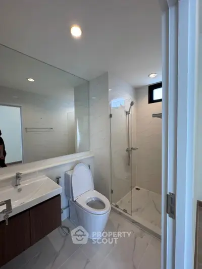 Modern bathroom with sleek fixtures and glass shower enclosure