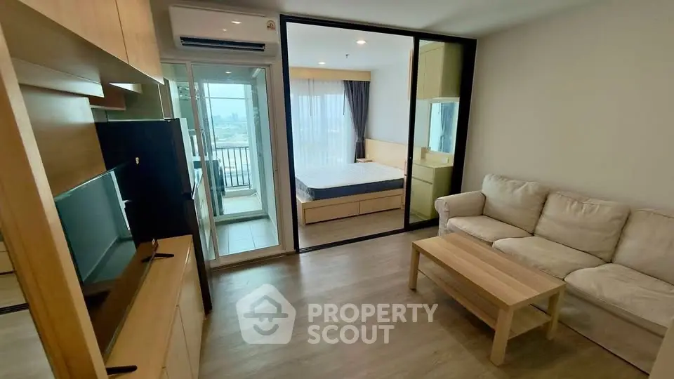 Modern apartment interior with cozy living room and bedroom, featuring a balcony view.