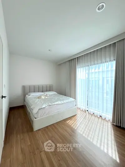 Bright and airy bedroom with large windows and modern decor
