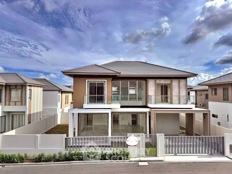 Modern two-story house with sleek design and spacious layout in a suburban neighborhood.