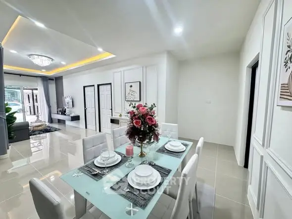 Modern open-plan dining and living area with elegant decor and natural light.