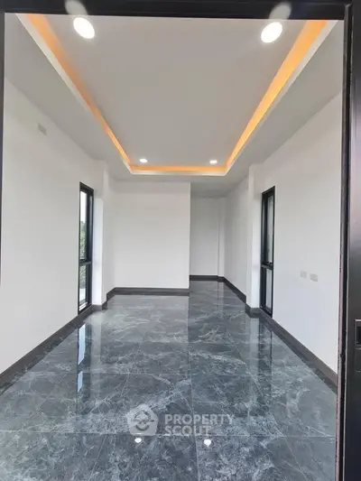 Spacious modern room with elegant marble flooring and recessed lighting