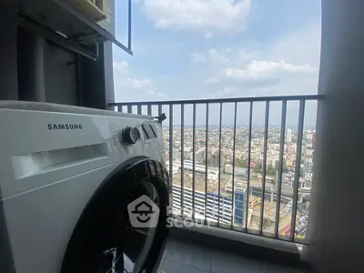 High-rise balcony with city view and washing machine, perfect urban living.