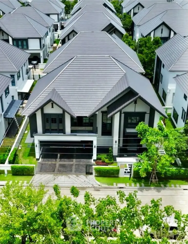Luxurious modern homes with sleek roofs in a serene suburban neighborhood.