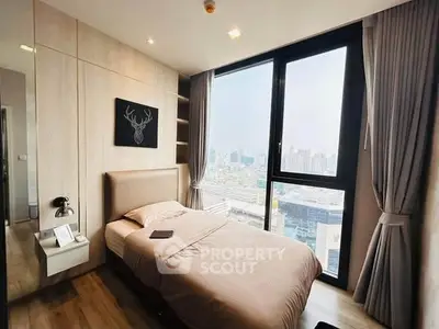 Modern bedroom with large window offering stunning city view, featuring cozy bed and elegant decor.