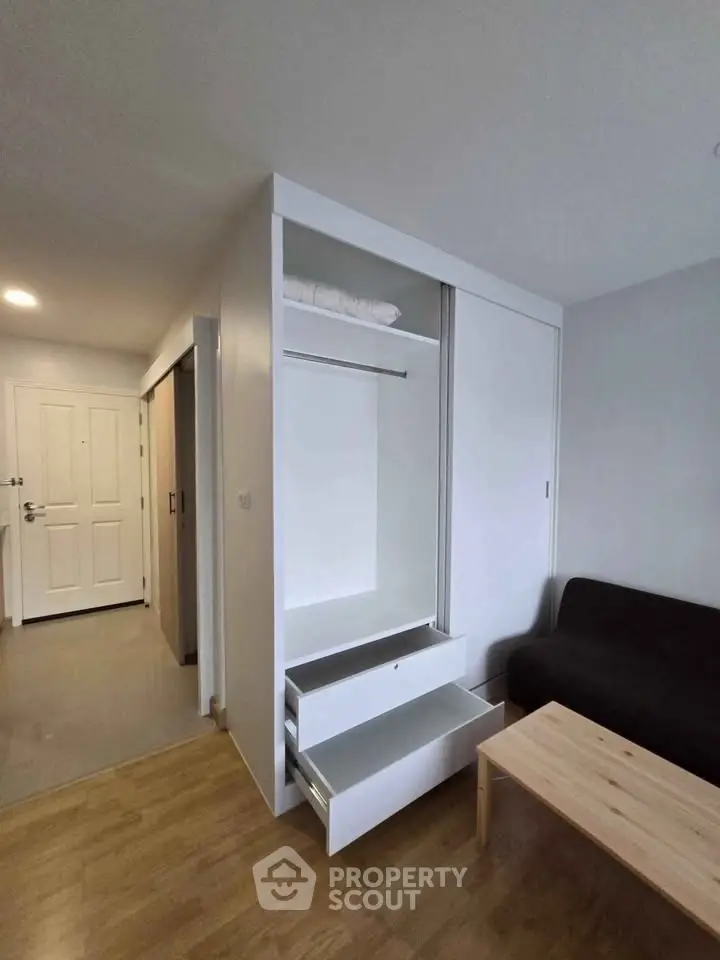 Modern apartment interior with sleek storage and cozy living area