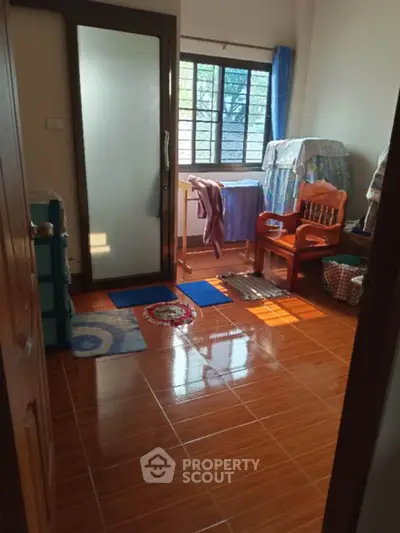 Cozy room with wooden flooring and natural light through window