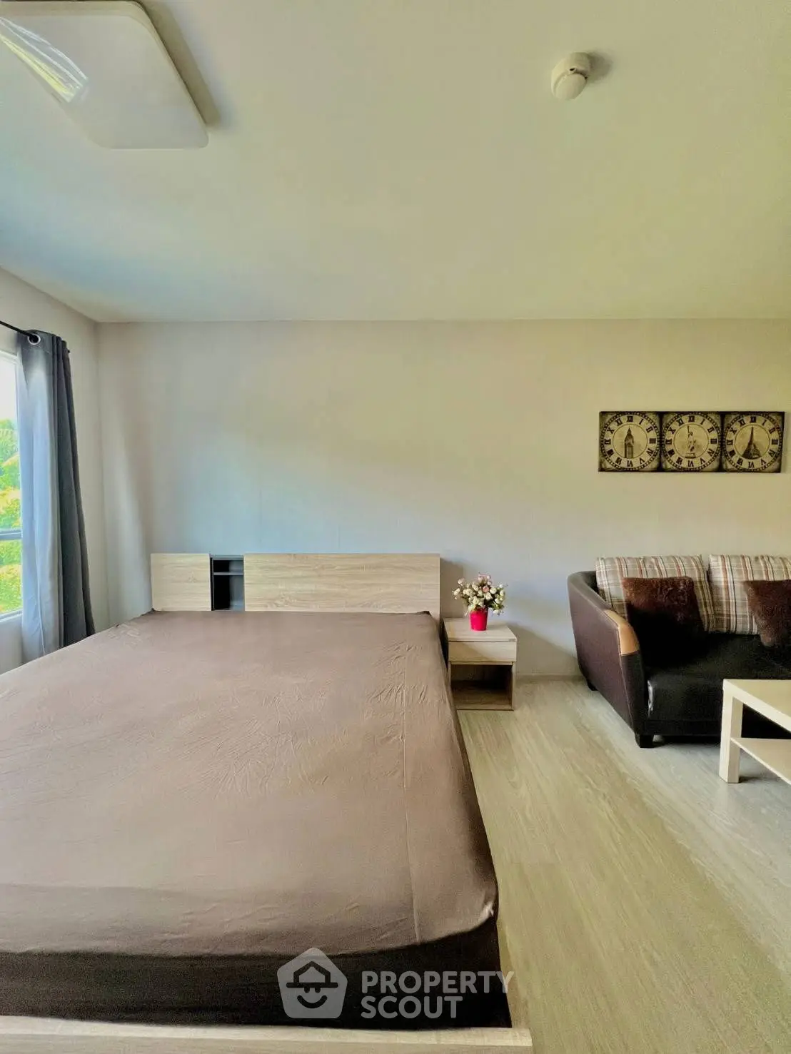 Spacious bedroom with modern decor and cozy seating area, perfect for relaxation.