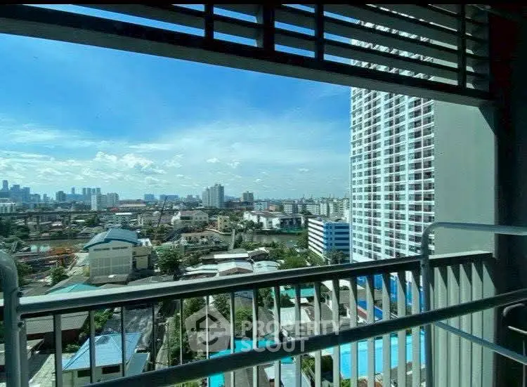 Stunning cityscape view from high-rise balcony with clear blue sky