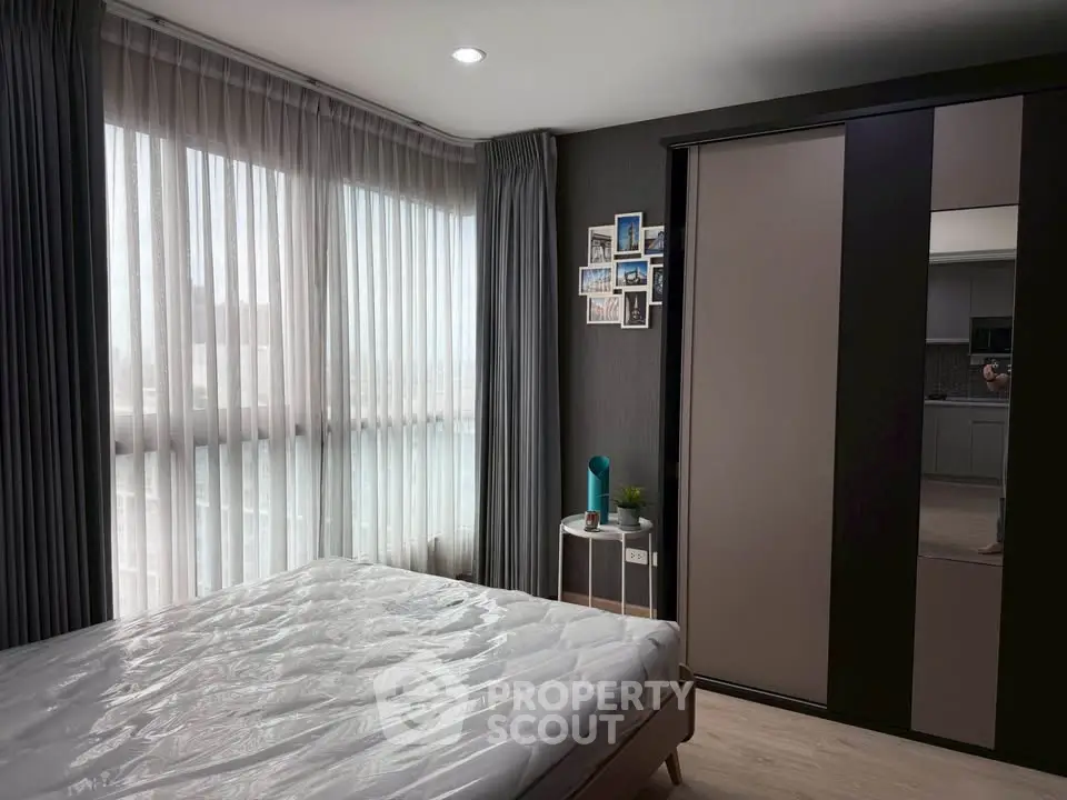 Modern bedroom with large window and stylish decor in urban apartment