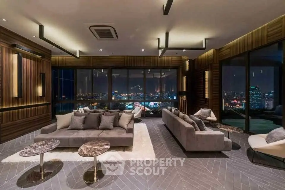 Luxurious modern living room with stunning city night view and elegant decor.