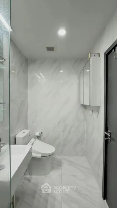 Modern bathroom with sleek white tiles and contemporary fixtures