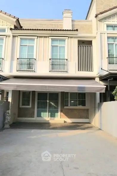 Charming townhouse exterior with modern facade and spacious driveway.