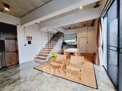 Spacious open-plan living area with modern design and natural light