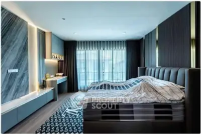 Luxurious modern bedroom with stylish decor and large windows for natural light.