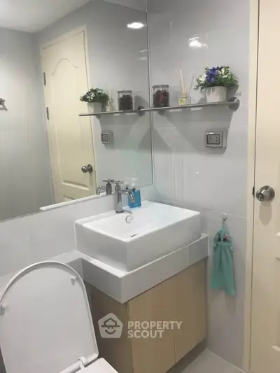 Modern bathroom with sleek sink and stylish decor in a contemporary home.