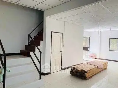 Spacious interior with staircase and natural light, ideal for customization.