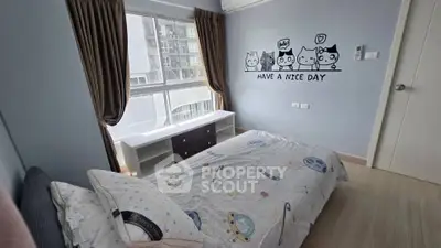 Charming bedroom with playful wall art and large window in modern apartment