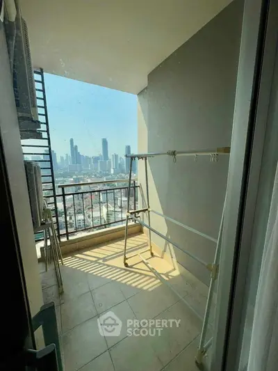 Spacious balcony with stunning city skyline view, perfect for relaxation and enjoying urban living.