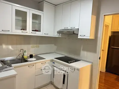 Modern white kitchen with sleek cabinets and electric stove