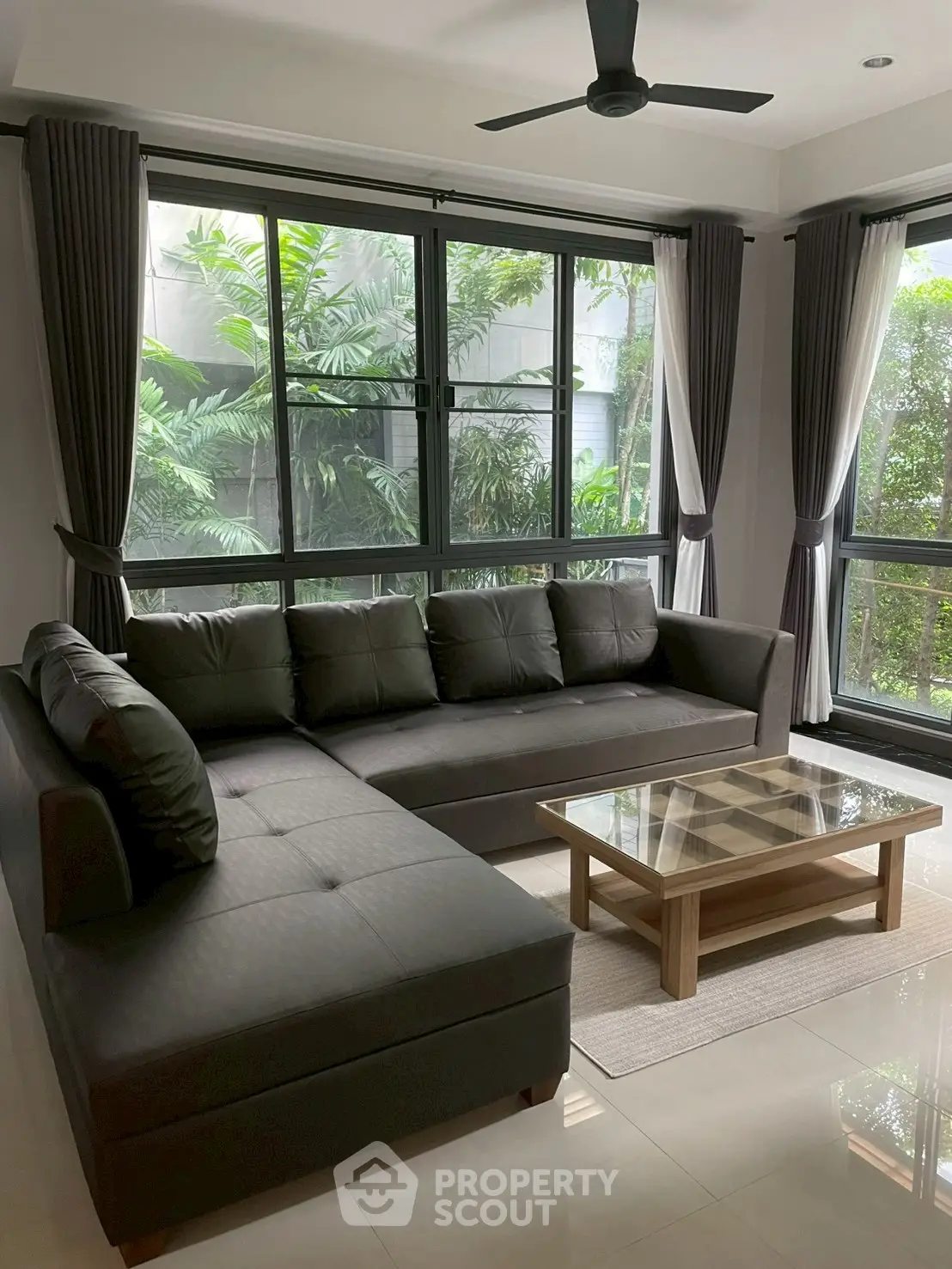 Spacious living room with large windows and modern sectional sofa