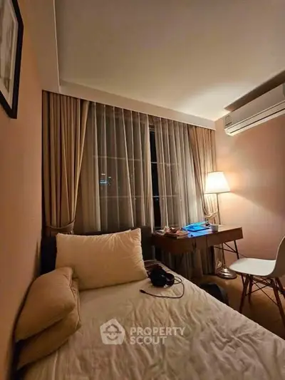 Cozy bedroom with elegant decor, featuring a comfortable bed, stylish desk, and ambient lighting.