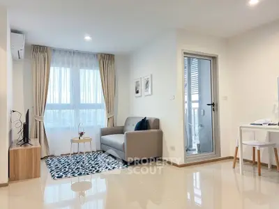 Modern living room with cozy sofa and balcony access in bright apartment