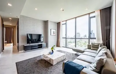 Luxurious modern living room with large windows and city view