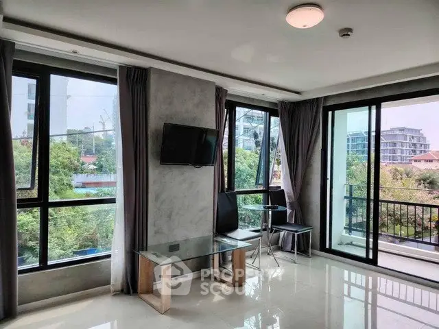 Spacious living room with large windows and balcony offering stunning views
